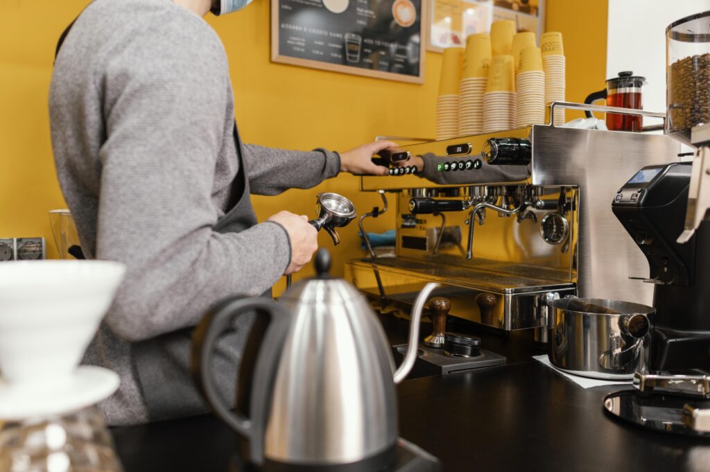 side-view-male-barista-working-coffeehouse (1)